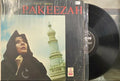Vinyl record with a cover featuring a person and architectural elements, labeled 'Pakeezah'.