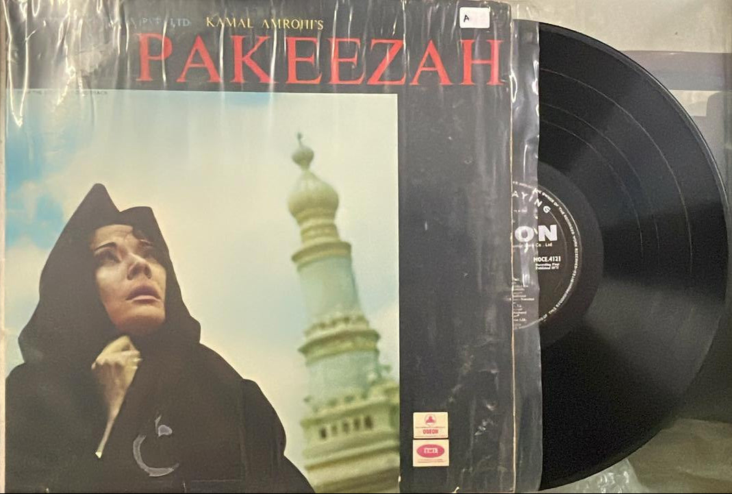 Vinyl record with a cover featuring a person and architectural elements, labeled 'Pakeezah'.