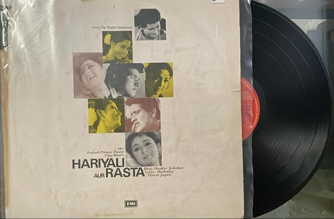 Vinyl record with a cover featuring a collage of faces on a beige background.