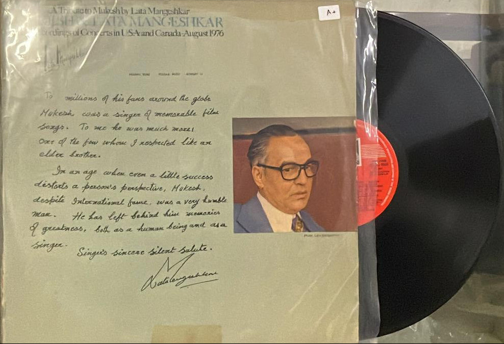 Record with a cover featuring text and a portrait, held by a stand.