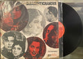 Vinyl record with cover featuring black and white portraits and red text on a textured surface.