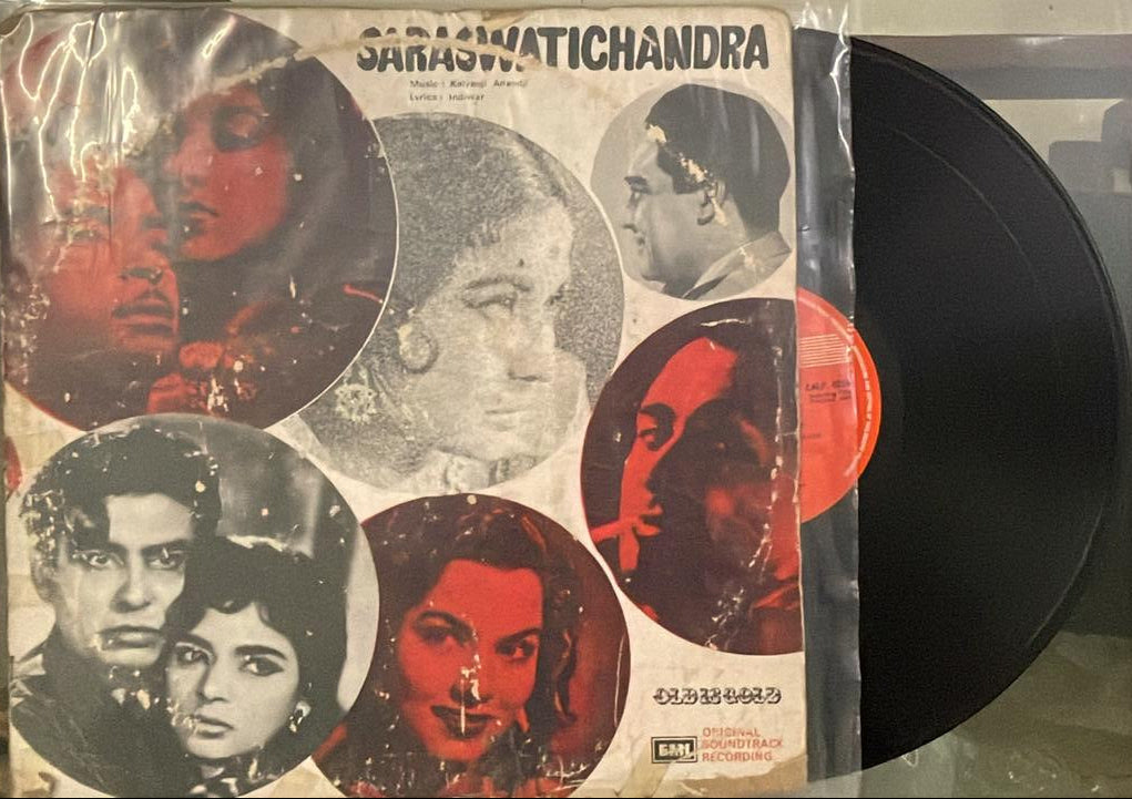 Vinyl record with cover featuring black and white portraits and red text on a textured surface.
