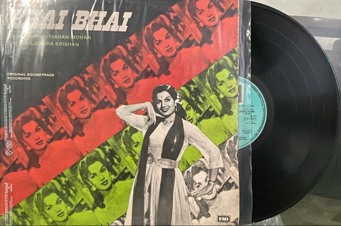 Vinyl record with a colorful cover featuring images of people on a table.