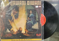 Vinyl record with a cover featuring two people and text, on a plain background.