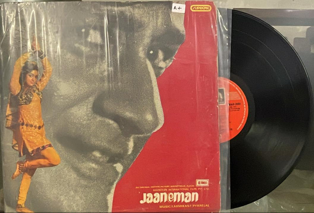 Vinyl record with a cover featuring a bear and a person, on a white surface.