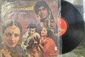 Vinyl record with a cover featuring a group of people, likely from a movie or theatrical performance.