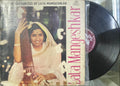 Vinyl record with cover featuring Lata Mangeshkar, showing a person in a white outfit.