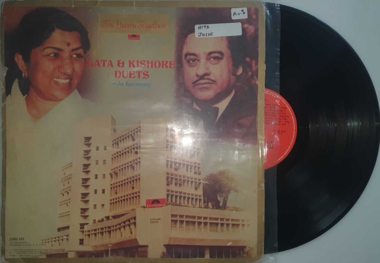 Vinyl record with a cover featuring two faces on a white background