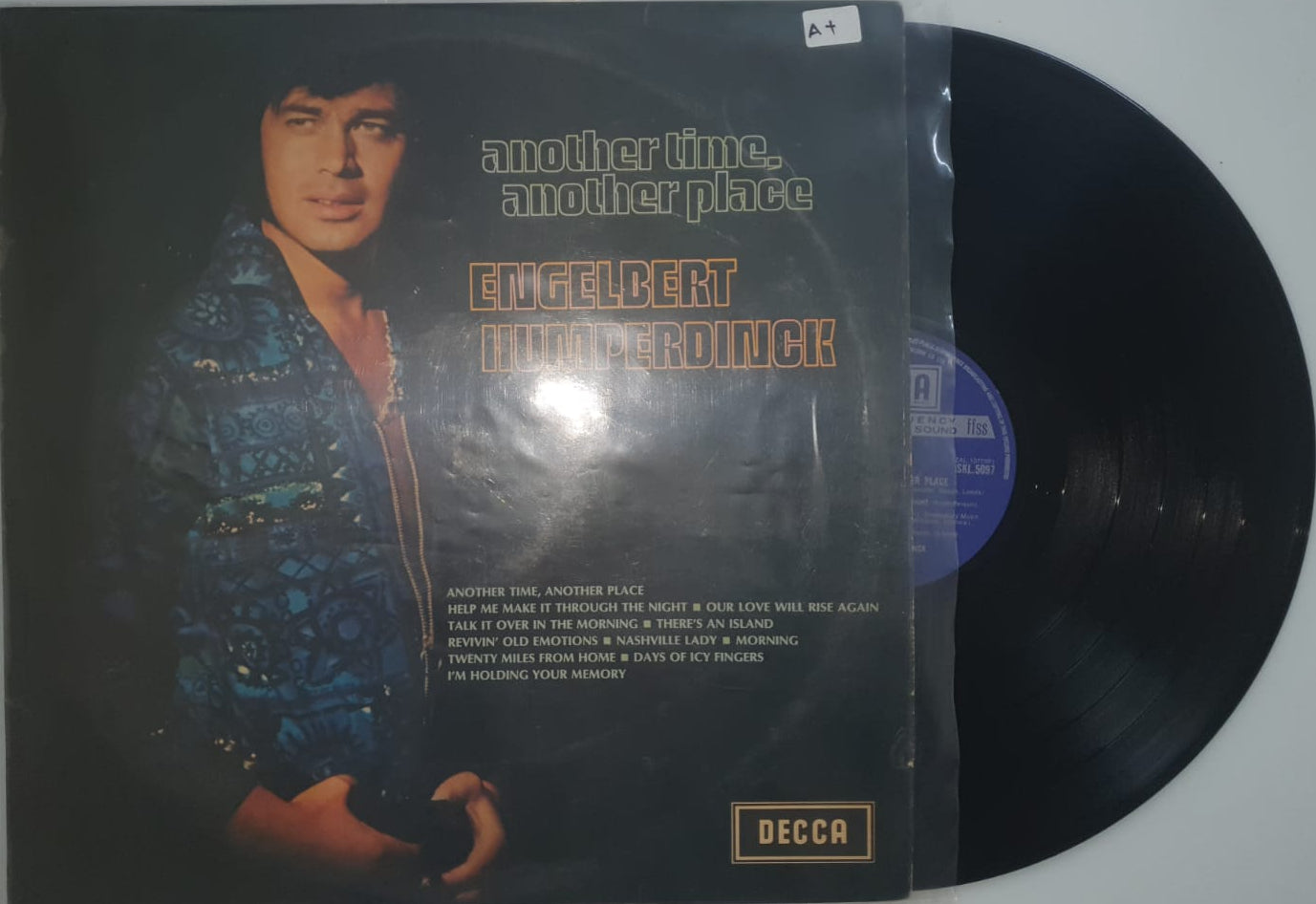 Vinyl record with a cover featuring a person's face and 'Decca' branding.
