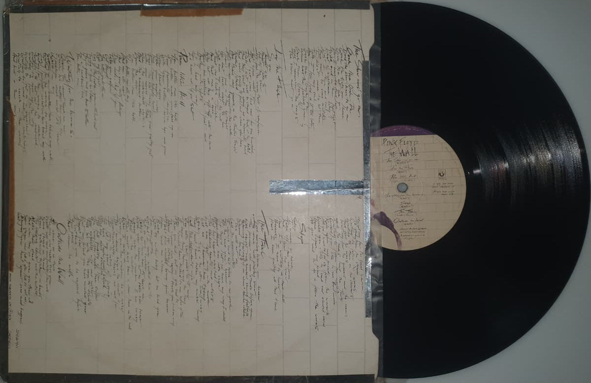 Vinyl record with a detailed inner sleeve on a light gray background