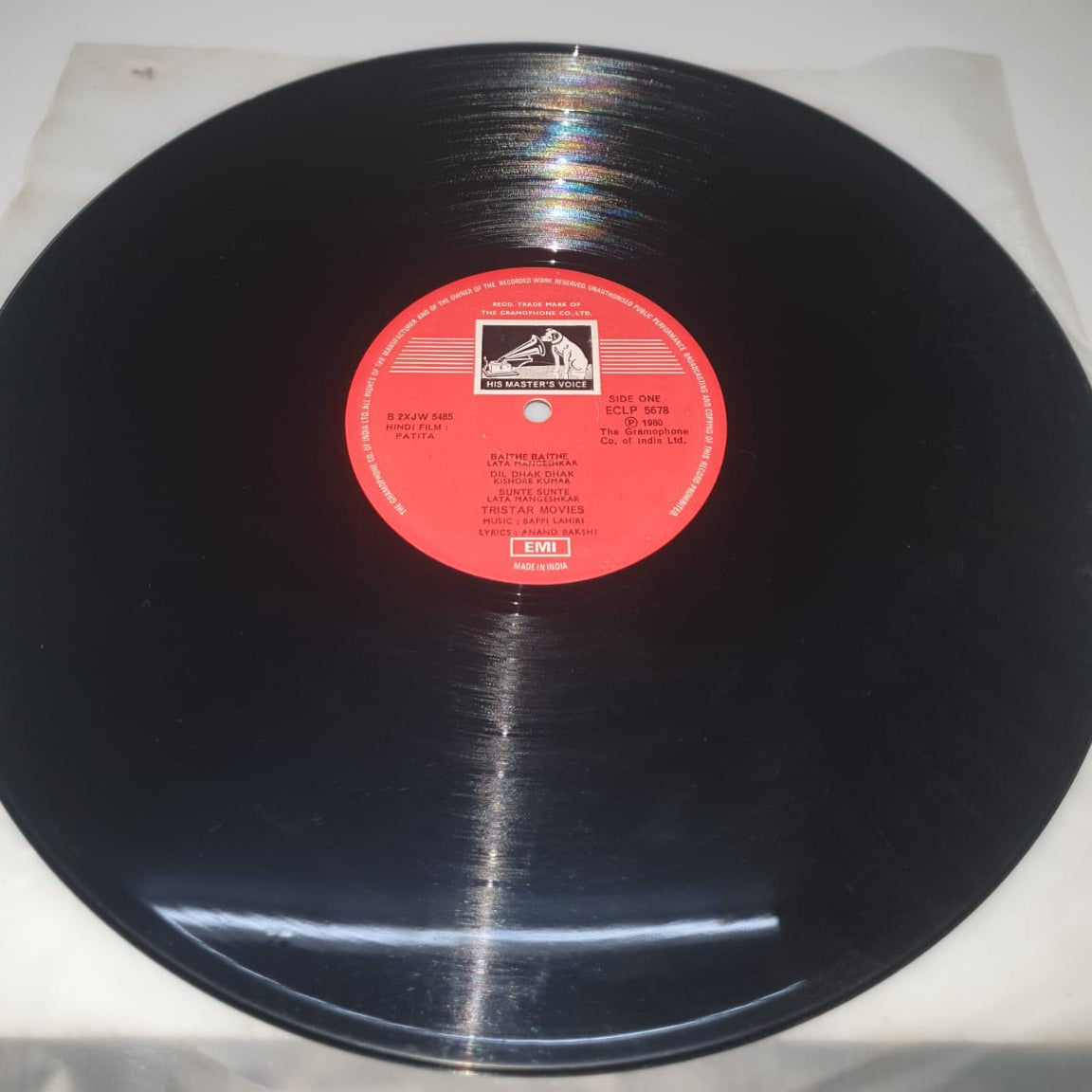 Vinyl record with a red label on a white background